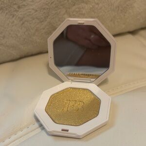 Fenty Beauty Shimmery Gold Highlighter Compact in kilowatt-Gold yellow tone.